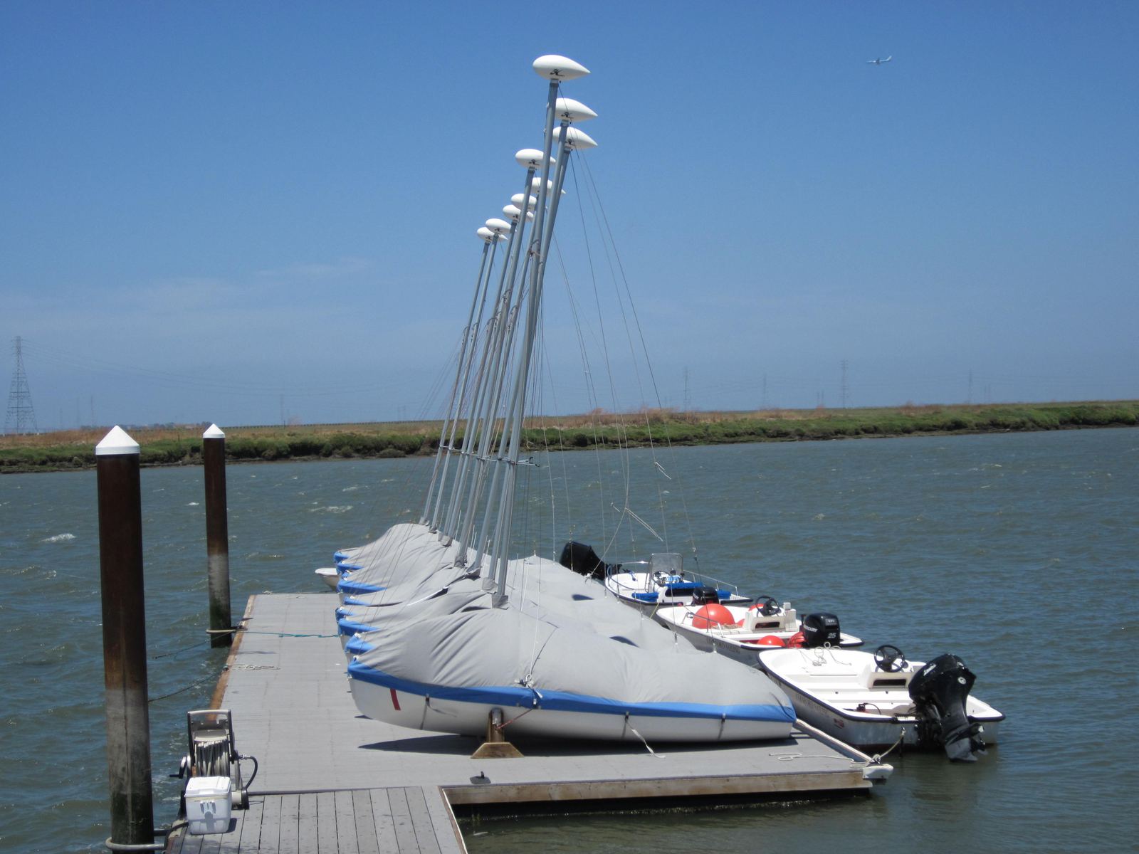 Covered club boats tied up along a dock